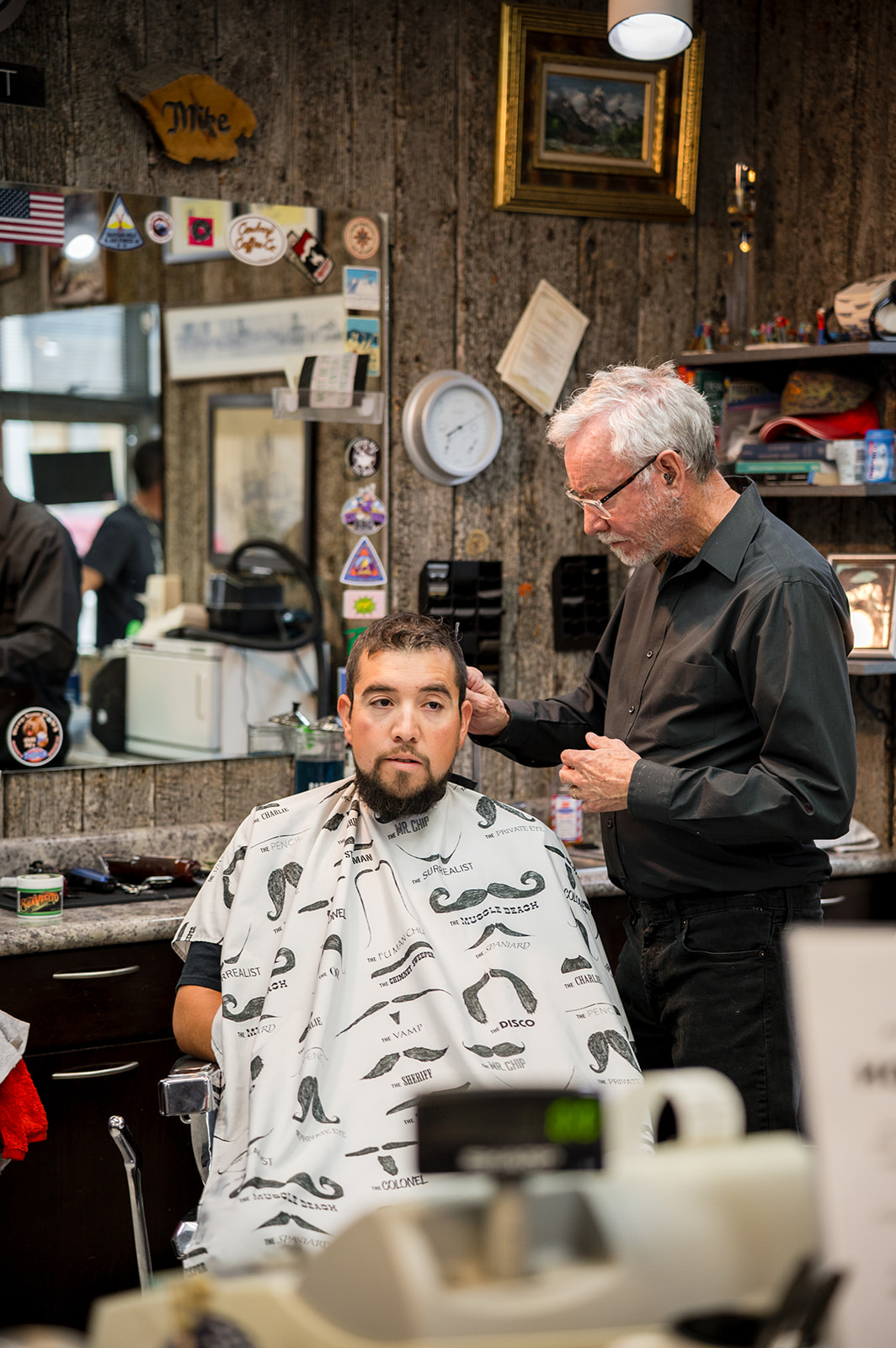 Barber at work with a client