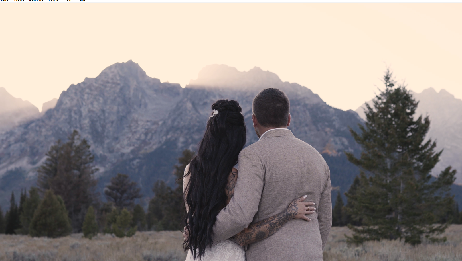 Bride and groom looking out at the Grand Tetons
